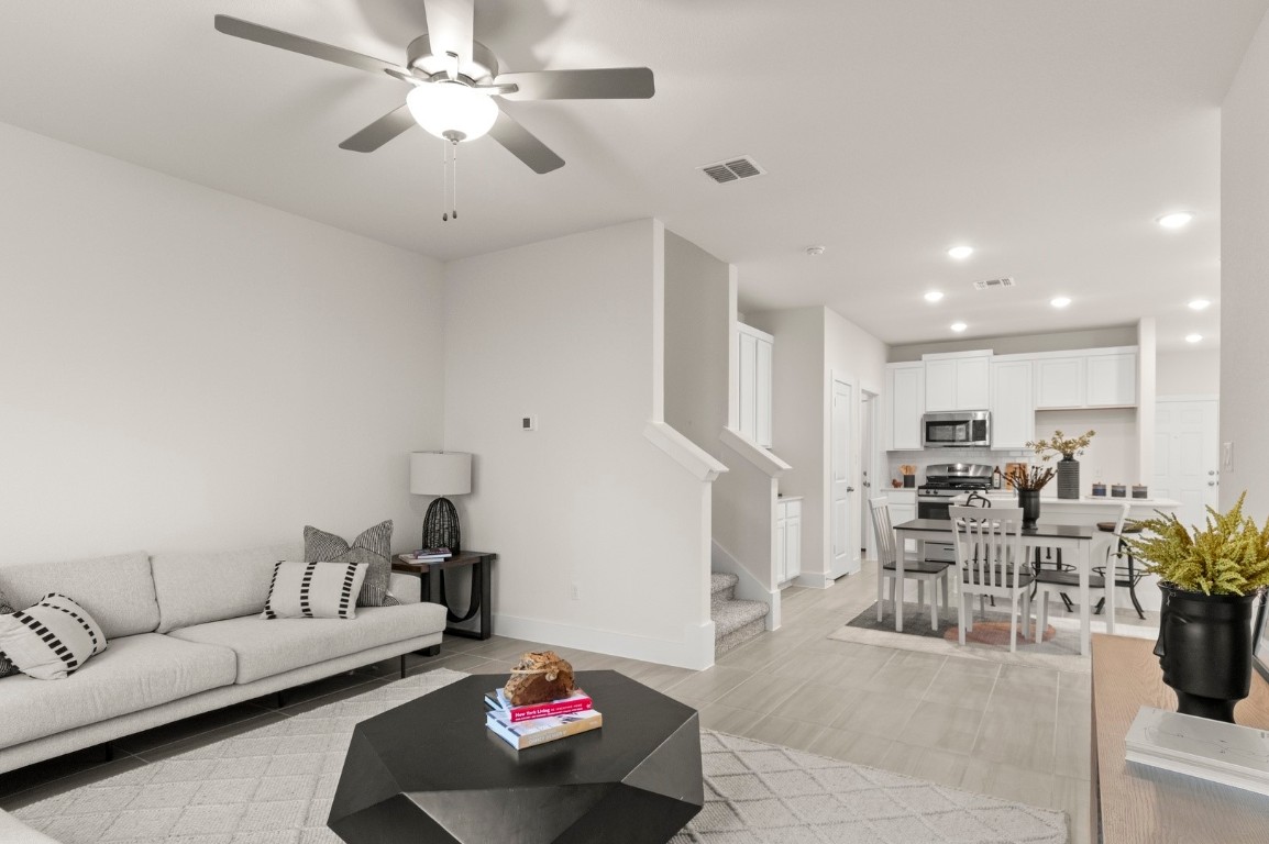 701 White Steppe Way Georgetown, TX 78626 - Photo 17 of 35 Living room featuring stairway, recessed lighting, a ceiling fan, and light wood-type flooring