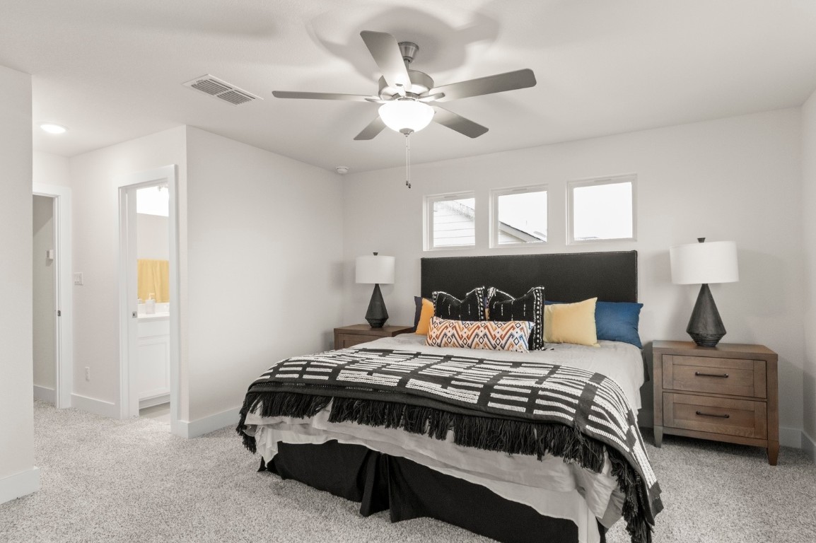 701 White Steppe Way Georgetown, TX 78626 - Photo 21 of 35 Bedroom featuring light carpet, a ceiling fan, and connected bathroom