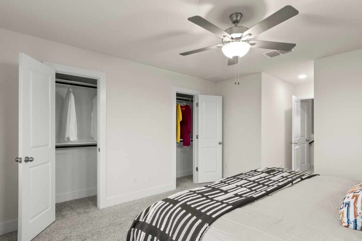 701 White Steppe Way Georgetown, TX 78626 - Photo 23 of 35 Bedroom featuring light carpet, a ceiling fan, and a closet