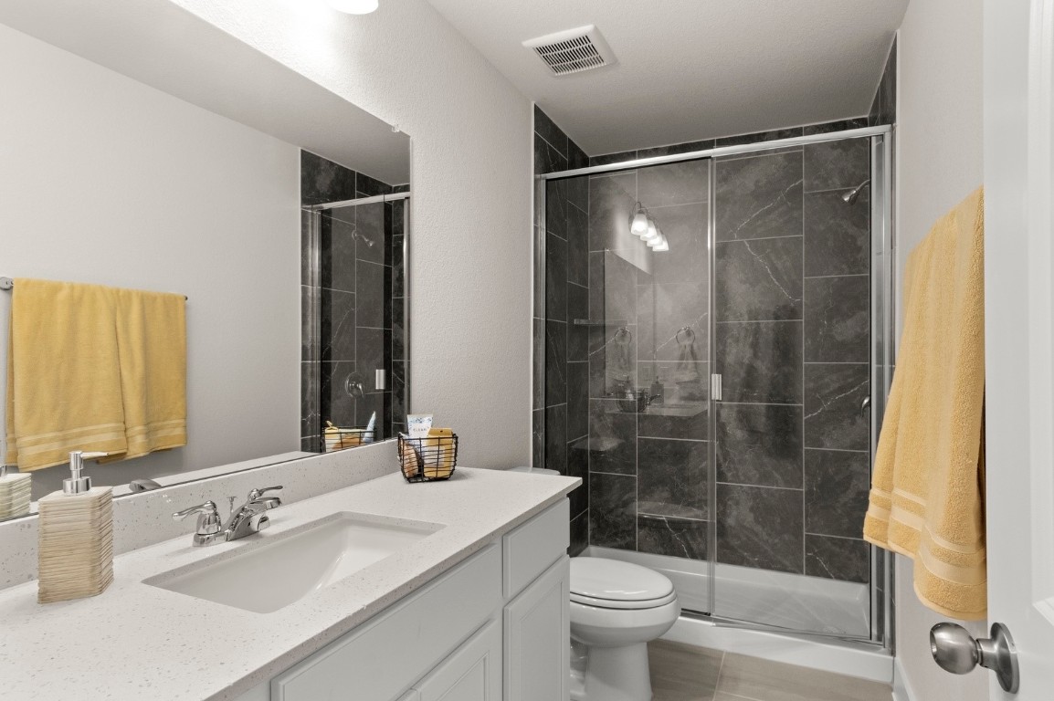 701 White Steppe Way Georgetown, TX 78626 - Photo 24 of 35 Bathroom with vanity and a shower stall