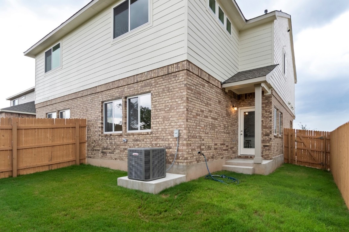 701 White Steppe Way Georgetown, TX 78626 - Photo 27 of 35 Rear view of house featuring brick siding and a fenced backyard