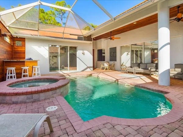 a view of a backyard with table and chairs