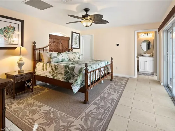 a bed room with a bed and a chandelier