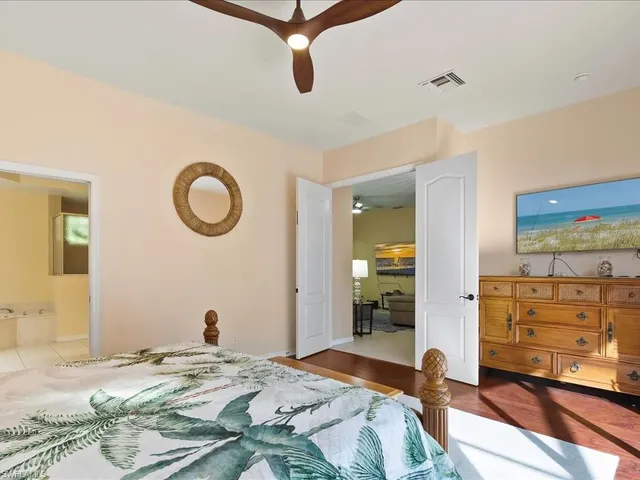 a bedroom with a bed and a large mirror