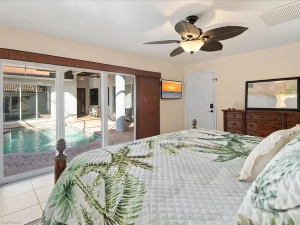 a bedroom with a bed and a large mirror