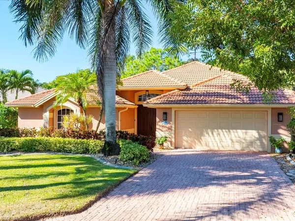 a front view of a house with a garden and patio