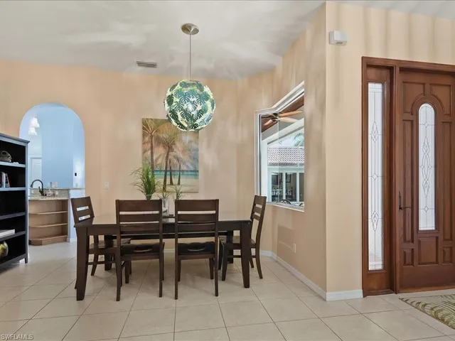 a view of a dining room with furniture wooden floor and a chandelier