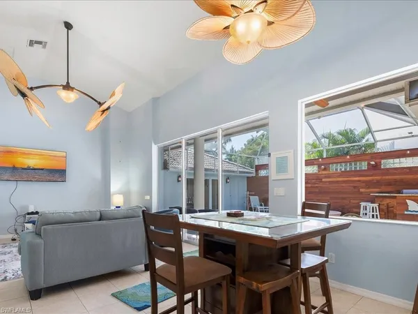 a view of a dining room with furniture wooden floor and a chandelier