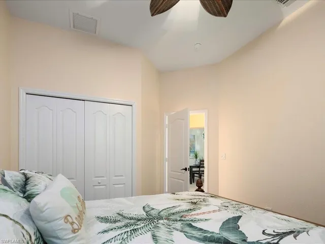 a bedroom with two beds and a chandelier