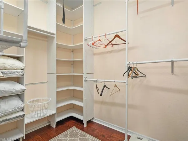 a view of walk in closet with empty racks