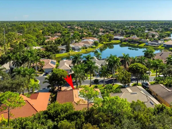 an aerial view of residential houses with outdoor space and trees