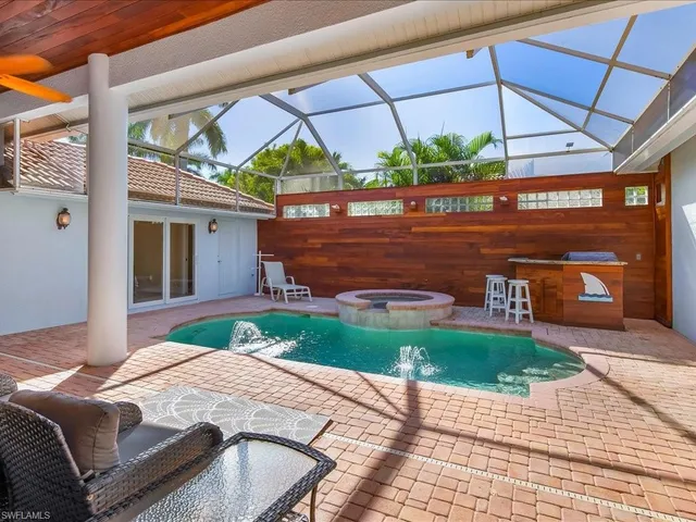 a backyard of a house with outdoor seating