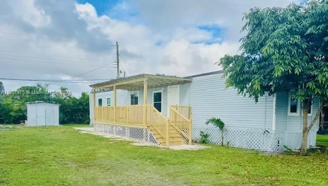 a view of a house with a yard and plants