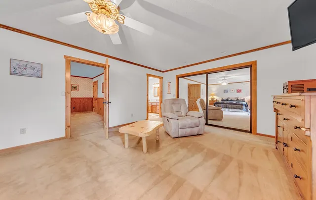 a bedroom with furniture and a large window