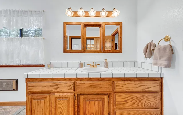 a bathroom with a sink and a mirror