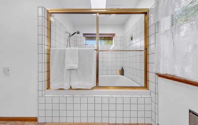 a bathroom with a bathtub and a shower