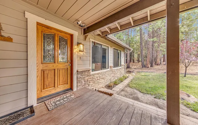 a view of a porch with wooden floor and floor to ceiling window
