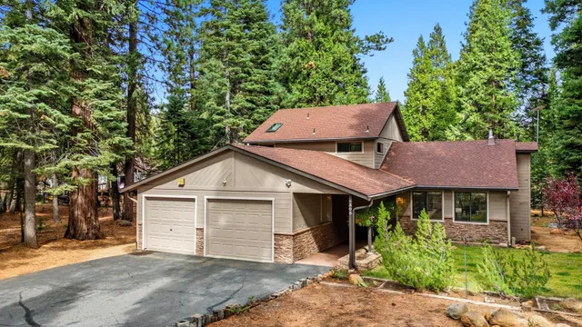 an aerial view of house with yard and outdoor seating
