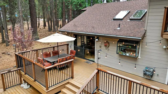 a view of a house with swimming pool and sitting area