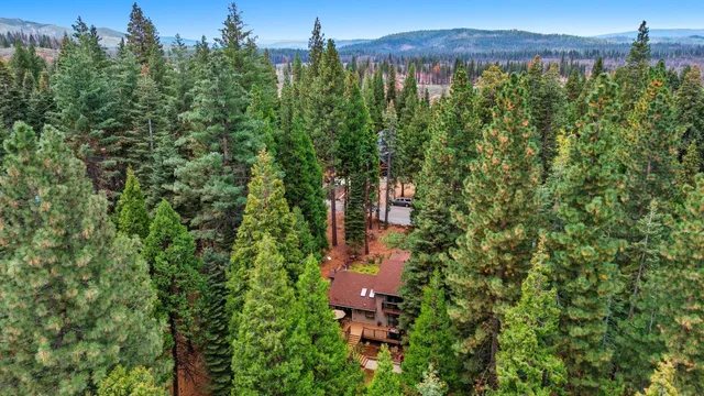 an aerial view of a house with a yard