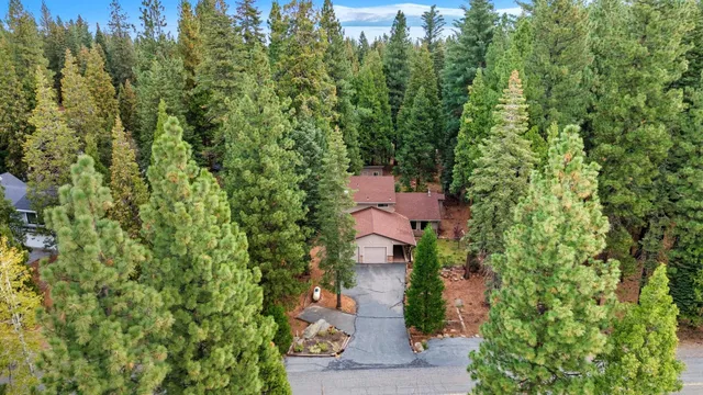 an aerial view of a house with a yard and garden