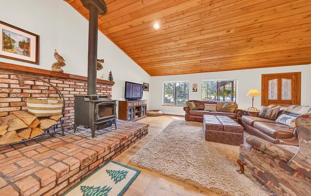 a living room with furniture a fireplace and a table