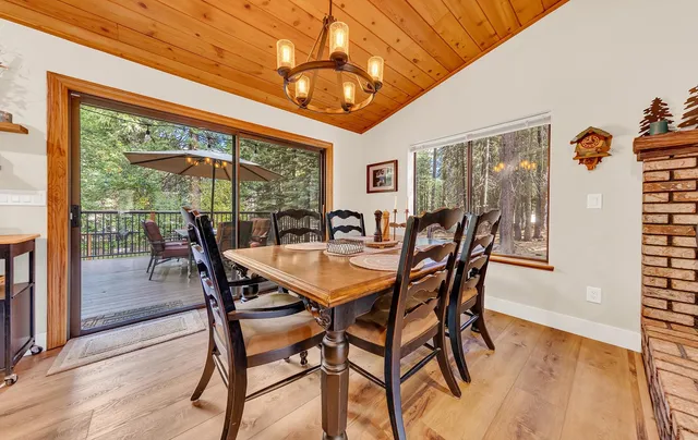 a view of a dining room with furniture large windows and wooden floor