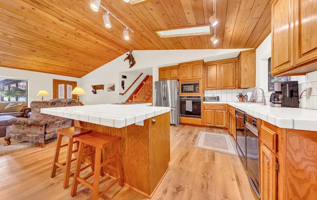 a kitchen with stainless steel appliances granite countertop a sink and cabinets