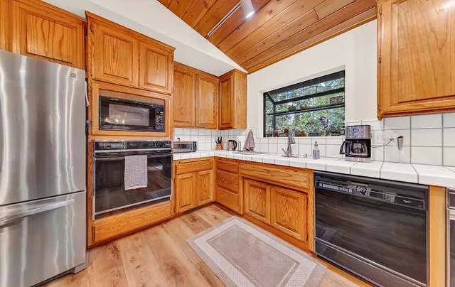 a kitchen with stainless steel appliances a stove sink and microwave