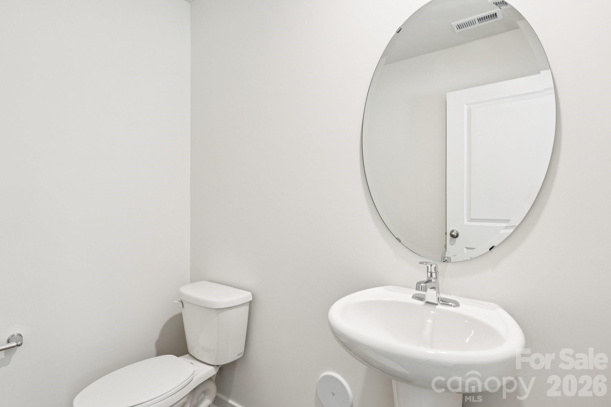 569 North Sparkleberry Street Chester, SC 29706 - Photo 13 of 40 a bathroom with a toilet sink and mirror