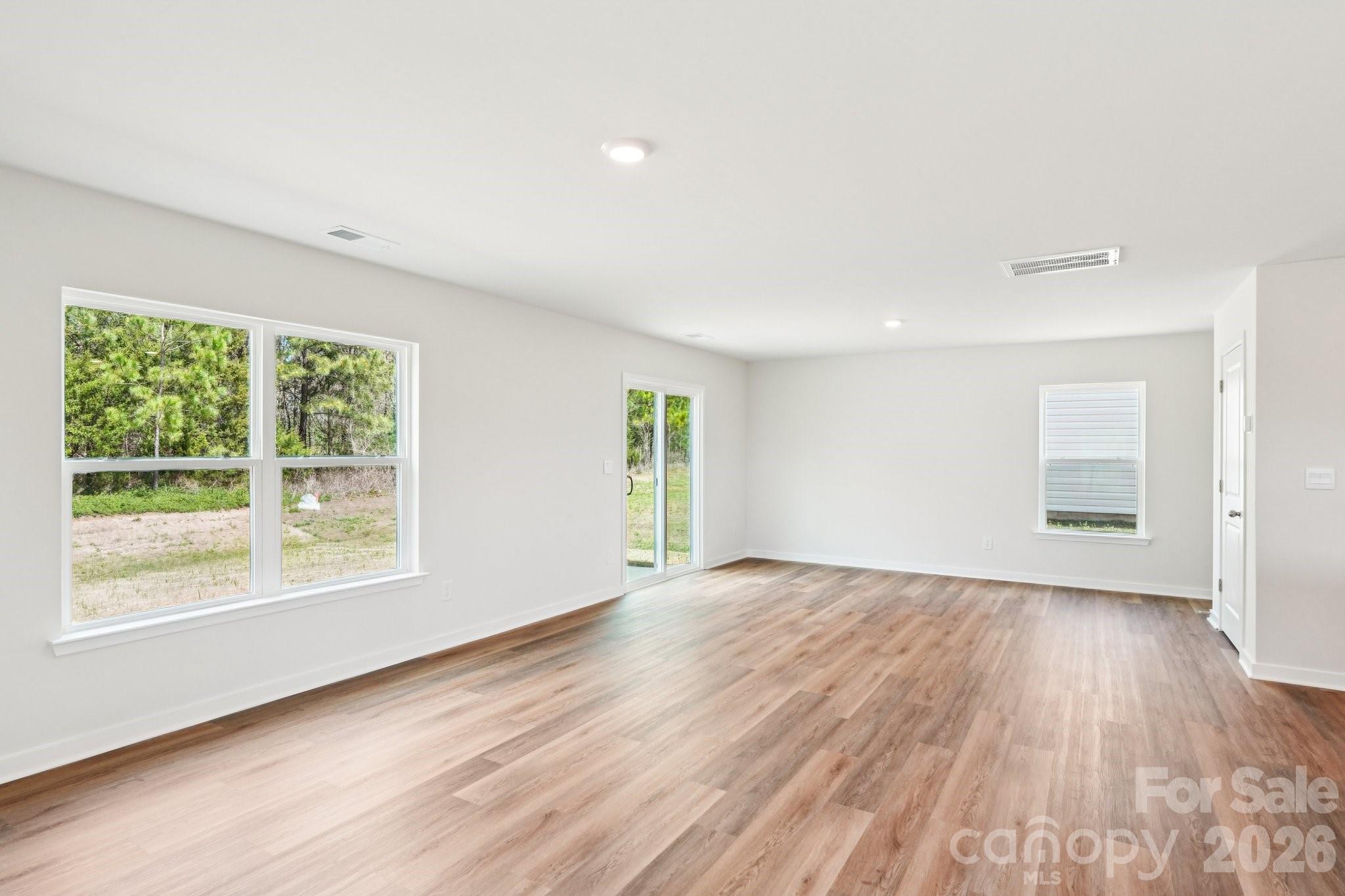 569 North Sparkleberry Street Chester, SC 29706 - Photo 4 of 40 a view of an empty room with wooden floor and a window