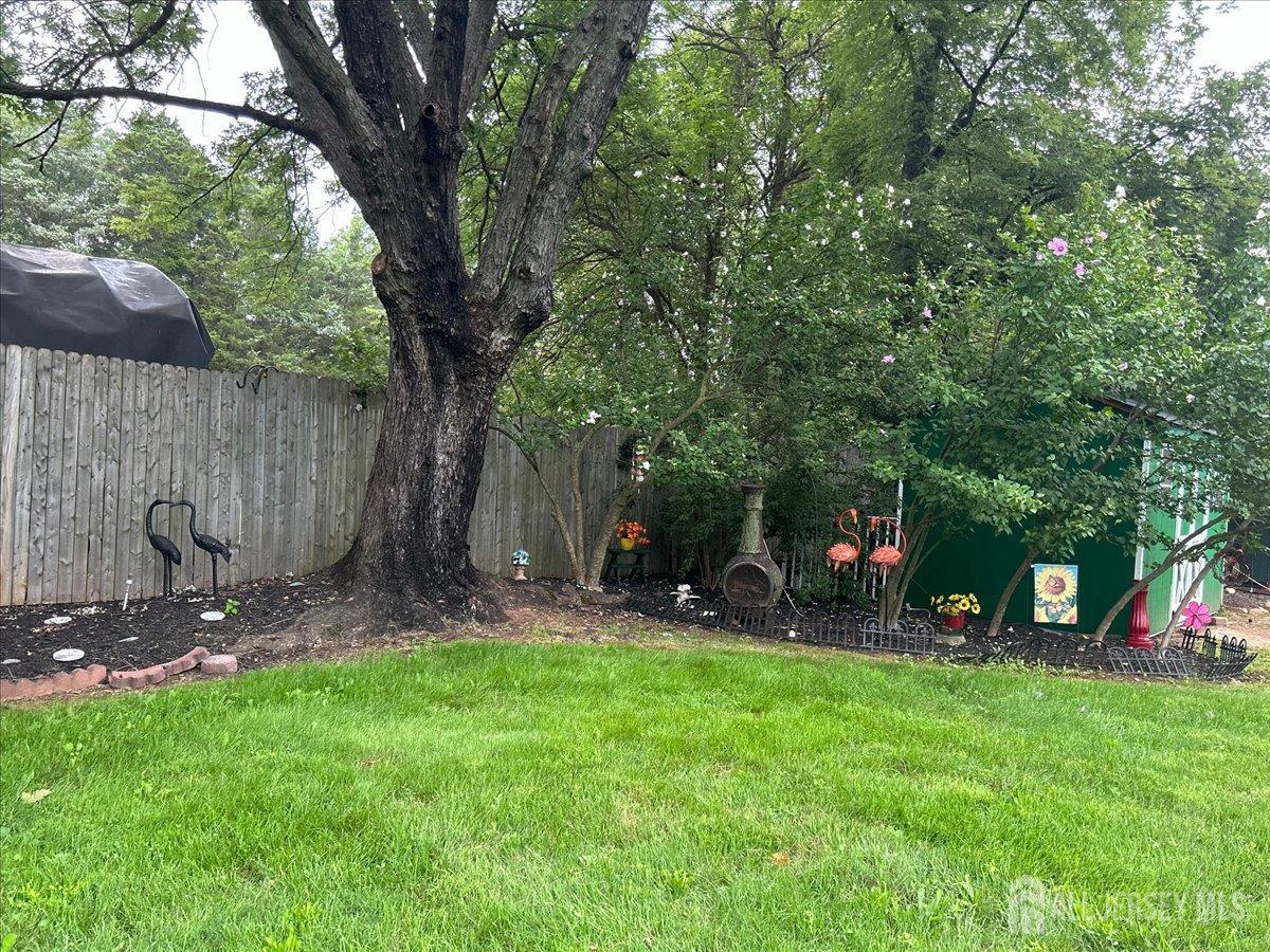 33 Ellison Road Somerset, NJ 08873 - Photo 23 of 38 a view of a backyard with a tree and a slide