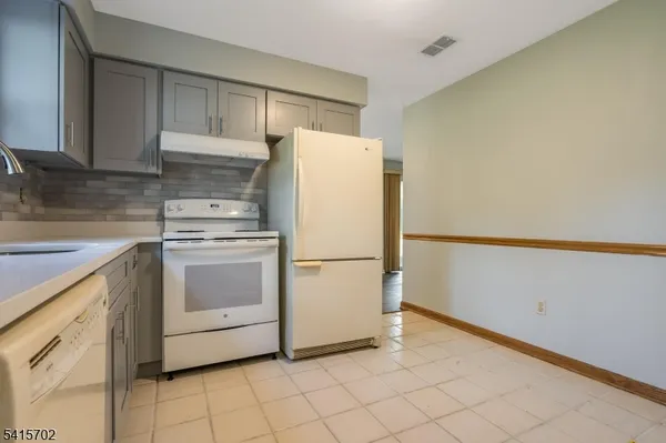 a white refrigerator freezer sitting in a kitchen