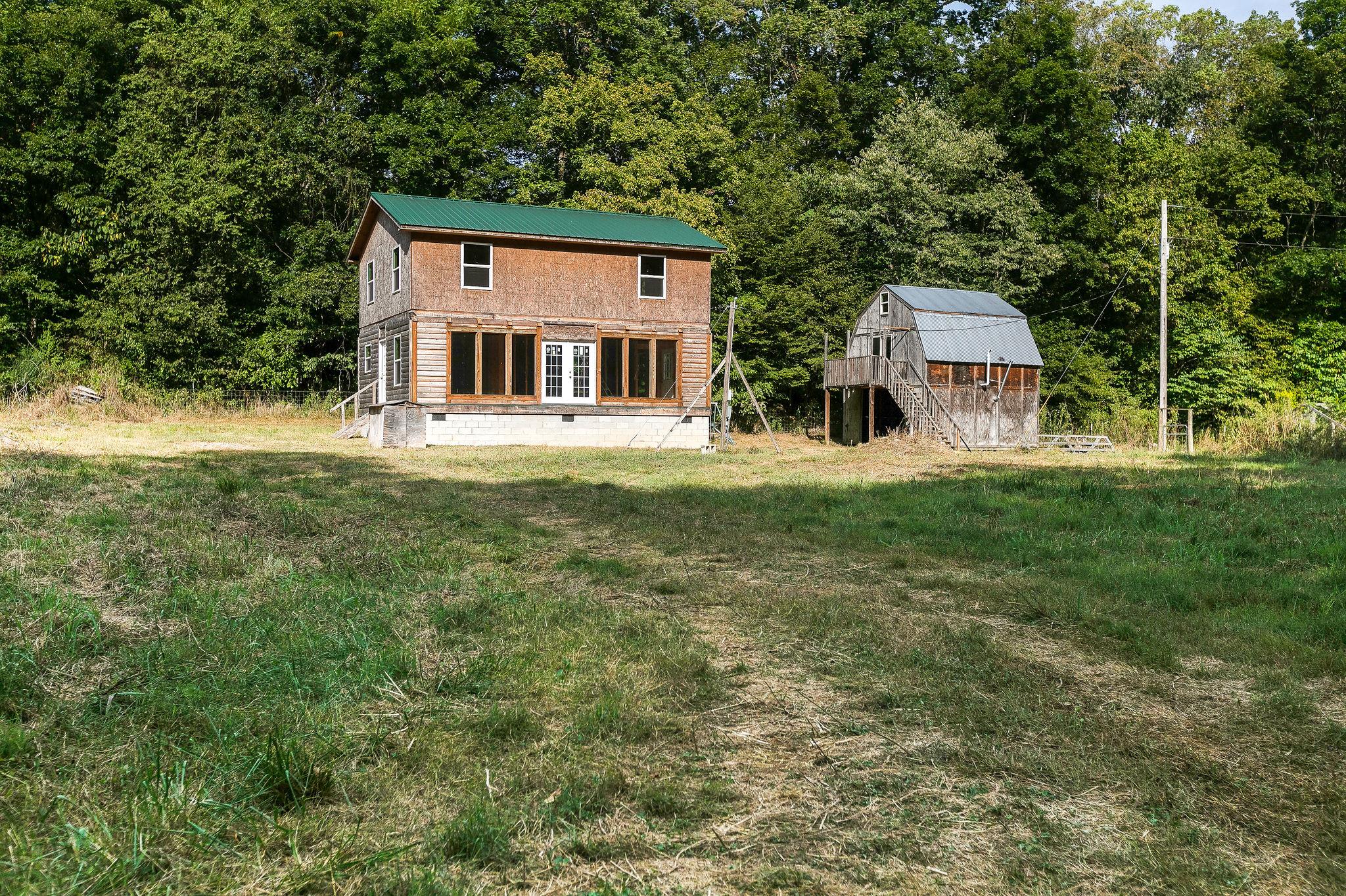6572 Hassell Creek Road Lyles, TN 37098 - Photo 1 of 29 a front view of a house with a garden