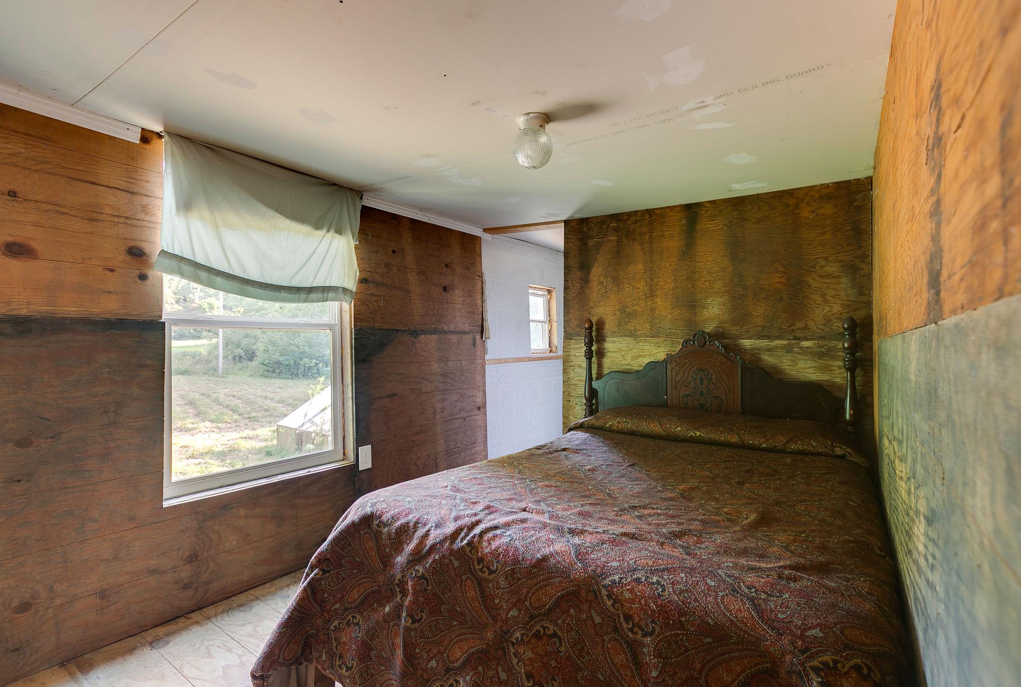 6572 Hassell Creek Road Lyles, TN 37098 - Photo 19 of 29 a bedroom with a bed and window