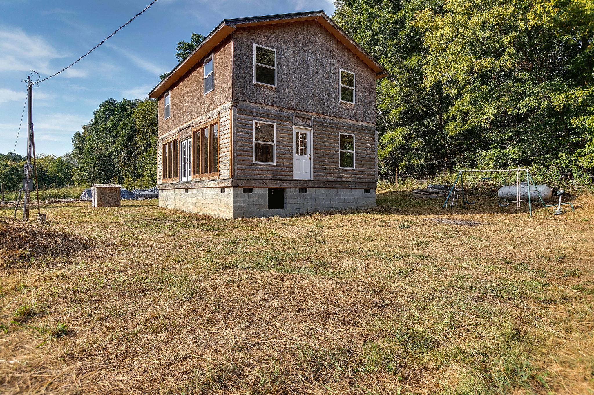 6572 Hassell Creek Road Lyles, TN 37098 - Photo 3 of 29 a front view of a house with a yard