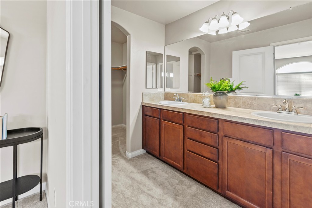 263 Spruce Street, Unit B Arroyo Grande, CA 93420 - Photo 27 of 36 a bathroom with a double vanity sink and a mirror