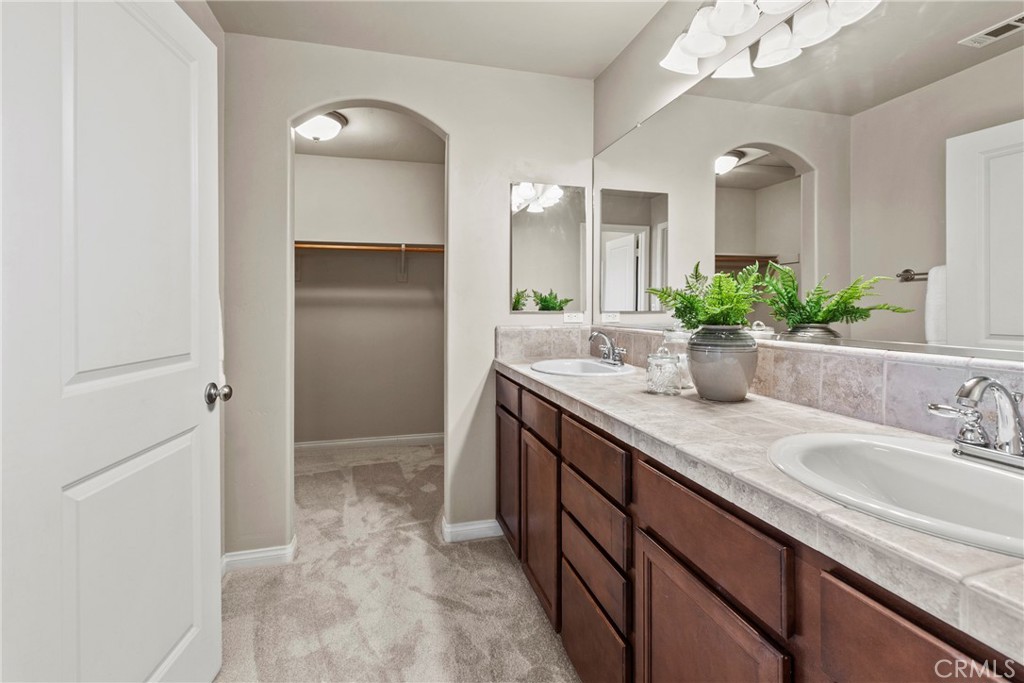 263 Spruce Street, Unit B Arroyo Grande, CA 93420 - Photo 28 of 36 a bathroom with a granite countertop sink and a mirror