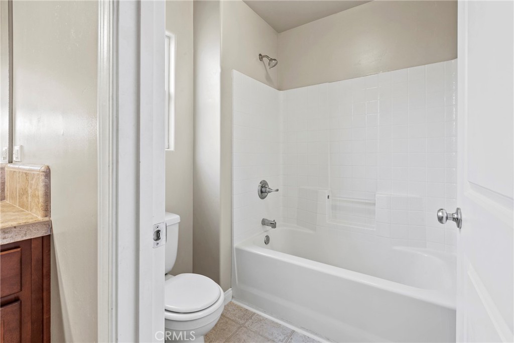 263 Spruce Street, Unit B Arroyo Grande, CA 93420 - Photo 30 of 36 a white bath tub sitting next to a white toilet