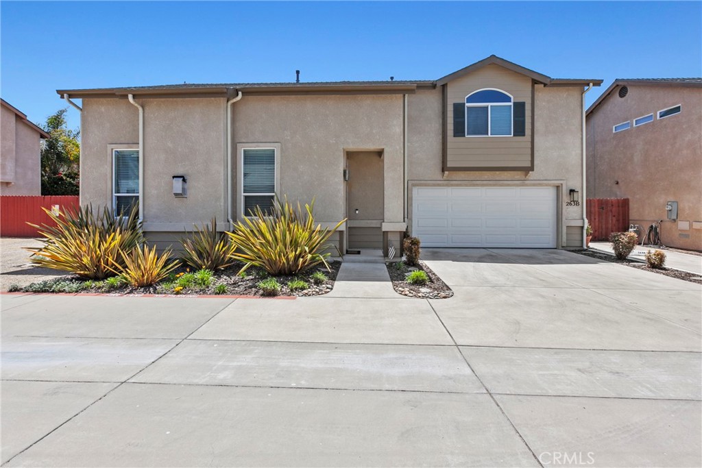 263 Spruce Street, Unit B Arroyo Grande, CA 93420 - Photo 3 of 36 a front view of a house with a yard and garage