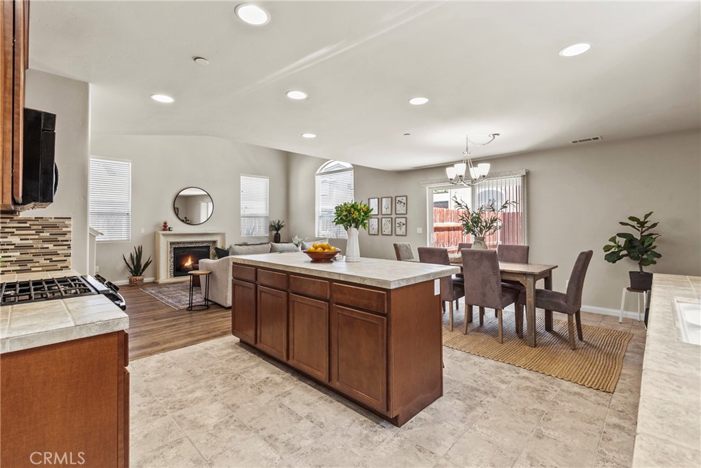 263 Spruce Street, Unit B Arroyo Grande, CA 93420 - Photo 8 of 36 a kitchen with stainless steel appliances granite countertop a stove top oven a sink a dining table and chairs with the living room