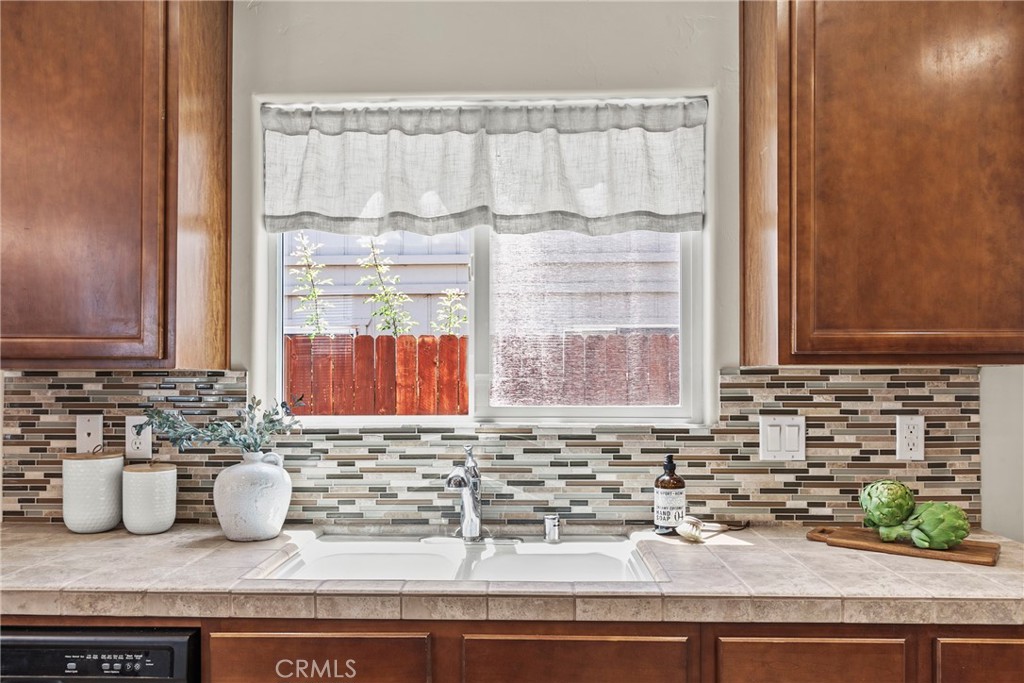 263 Spruce Street, Unit B Arroyo Grande, CA 93420 - Photo 9 of 36 a kitchen with a granite countertop sink and white cabinets