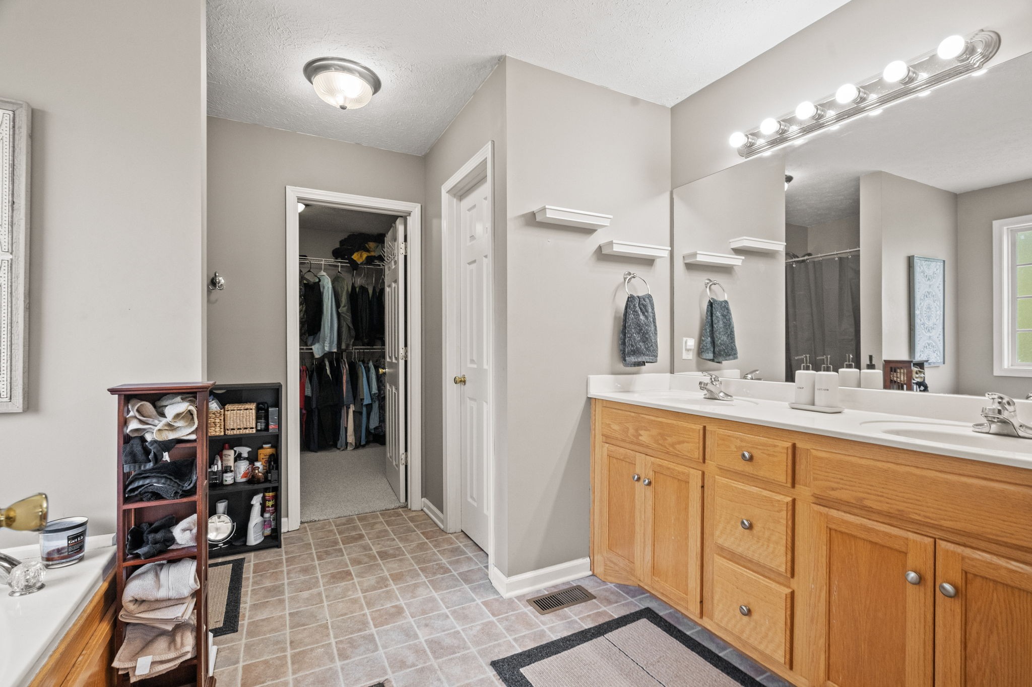 1051 Jacob's Valley Road Joelton, TN 37080 - Photo 15 of 45 a spacious bathroom with a double vanity sink a mirror and a shower