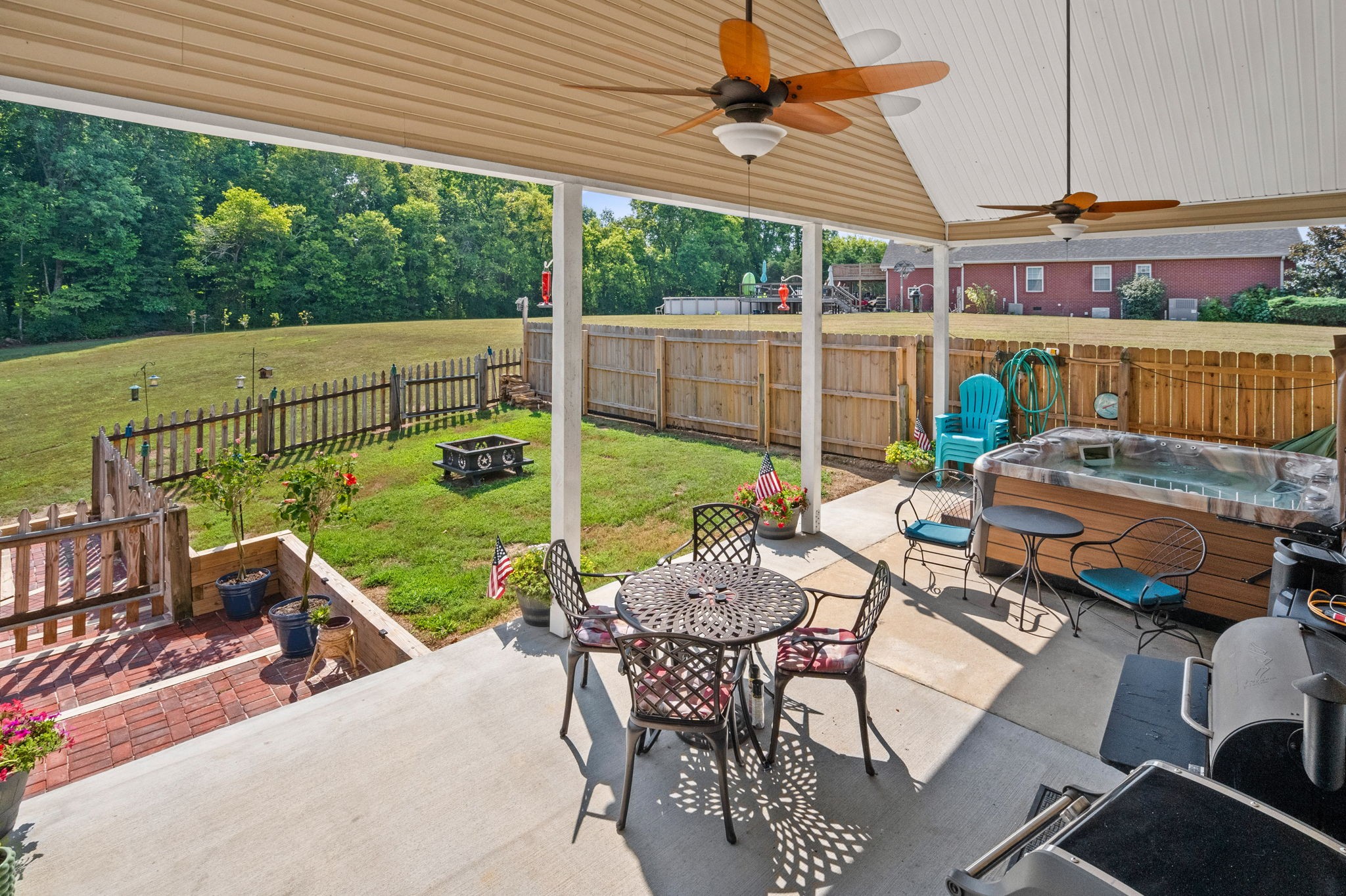 1051 Jacob's Valley Road Joelton, TN 37080 - Photo 27 of 45 a view of a patio with table and chairs potted plants with wooden floor and fence