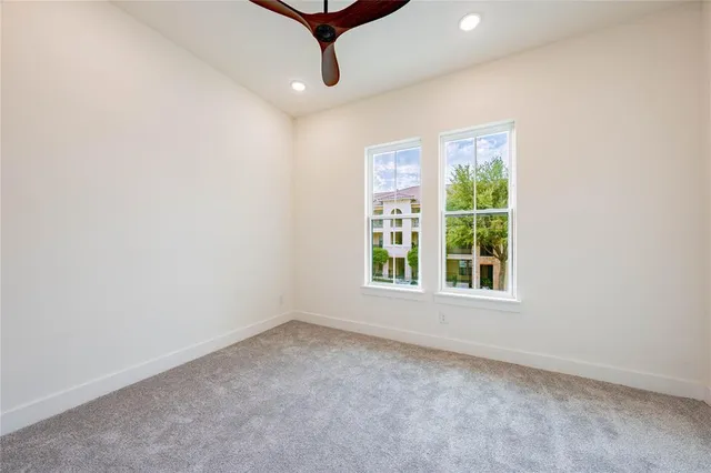 a bedroom with a bed and a ceiling fan