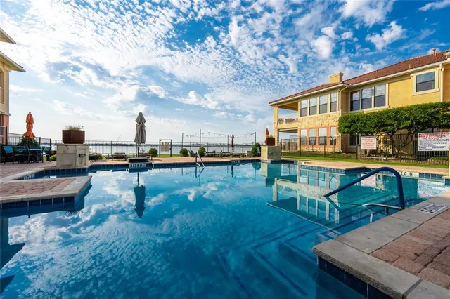 an aerial view of a house with swimming pool and outdoor seating