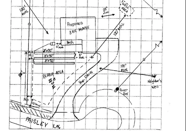 a sign board on a road next to a building