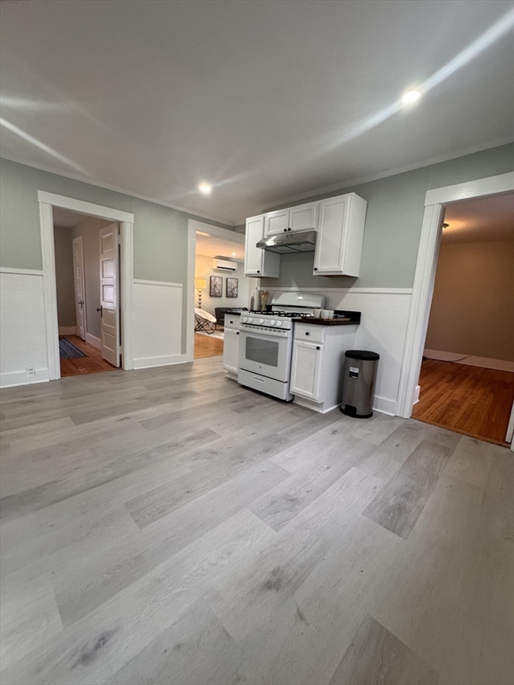 18 Emerald Avenue, Unit 2 Webster, MA 01570 - Photo 12 of 26 a large kitchen with stainless steel appliances granite countertop a stove and a refrigerator