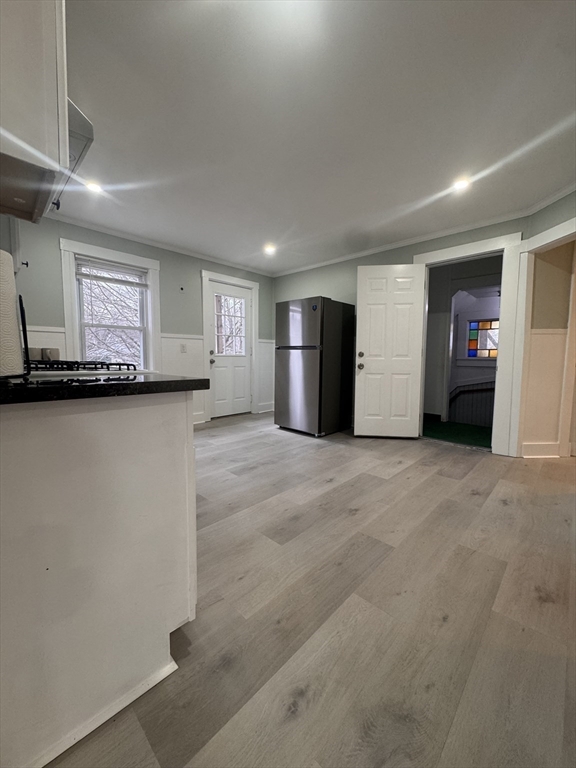 18 Emerald Avenue, Unit 2 Webster, MA 01570 - Photo 14 of 26 a view of a livingroom with a kitchen and a window