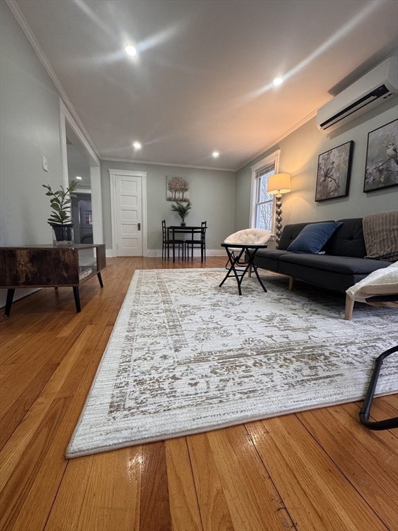 18 Emerald Avenue, Unit 2 Webster, MA 01570 - Photo 3 of 26 a living room with furniture and a wooden floor